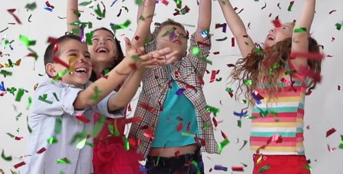 Children Celebrate with Falling Confetti and Joy