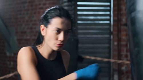 Closeup Face of Strong Fitness Lady Showing Beating Boxing in Gloves at Box Studio Slowmo