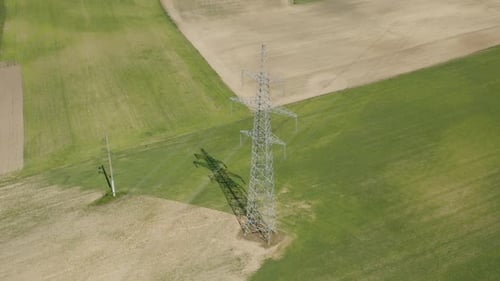 Aerial View of Power Lines Over Fields