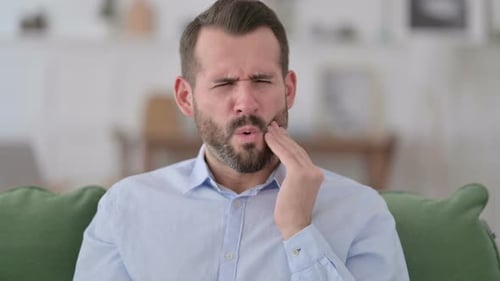 Sick Young Man Having Toothache at Home