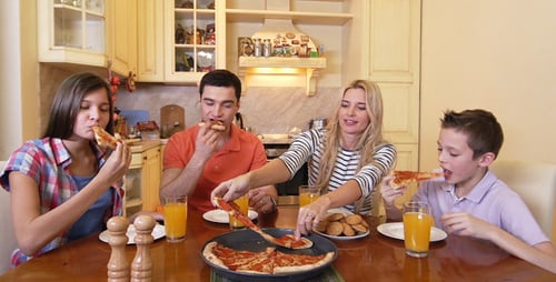 Family Enjoys Pizza Meal Together at Home