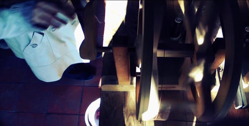 Person Winding Machine Made From Wood Overhead View