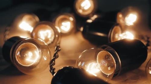 Close Up of Christmas Garland with Transparent Light Bulbs in Stock Warehouse