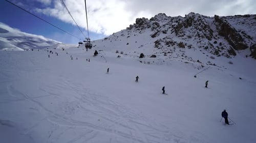 Skiers Descend Snow Covered Mountain During Winter