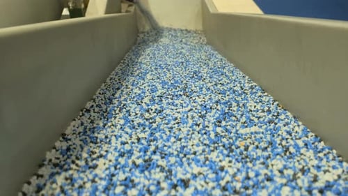 Conveyor Belt Transporting Small Pieces of Plastic