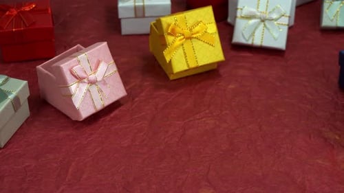 Colorful Miniature Gift Boxes on Red Background
