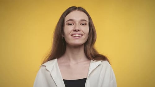 Woman Smiling Portrait Against Yellow Background