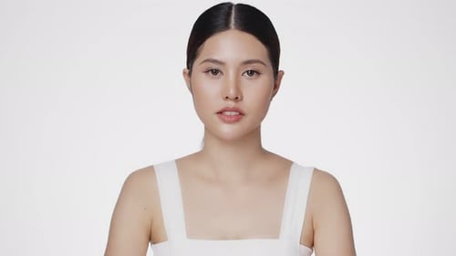 Attractive Woman Posing Against a White Background