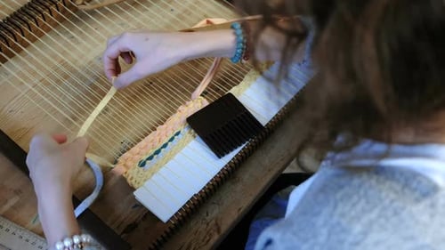 Woman Weaving Colorful Yarn on Wooden Loom