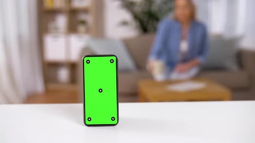 Smartphone with Green Screen on Table at Home 102