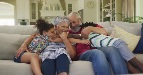 Grandparents Enjoy Loving Embrace from Grandchildren at Home
