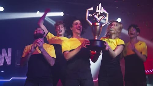 Happy Gamers Celebrating Victory Under Spotlights