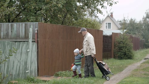 Grandpa And Grandson Coming Into Gate