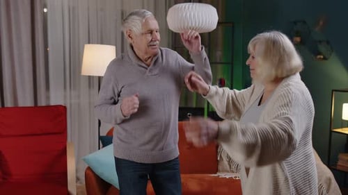 Elderly Couple Dancing Together at Home