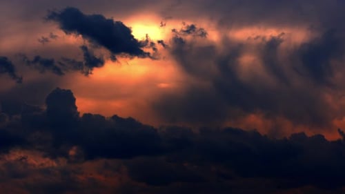 Brightly Red Cumulus Clouds Swirl at Sunset