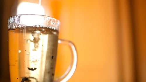 Steaming Tea Being Prepared in Clear Glass Mug