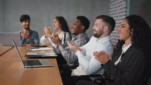 Employees Clapping at a Meeting in Office