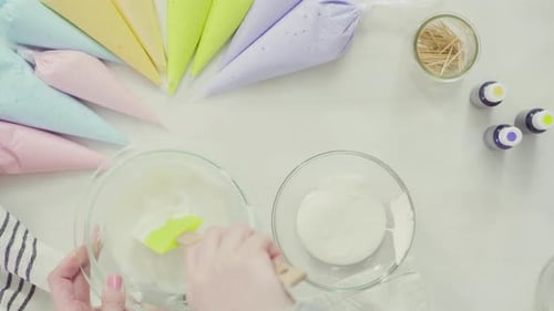 Step by step. Flat lay. Mixing royal icing to decorate Easter sugar cookies.