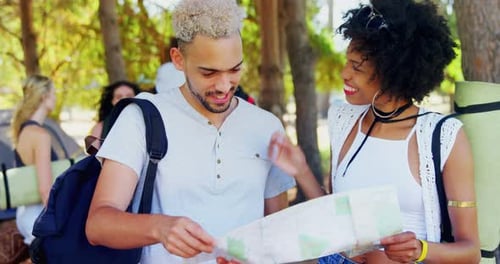 Friends Reviewing Map Outdoors