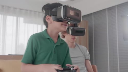 Boy and Adult Play Video Games with VR Headsets