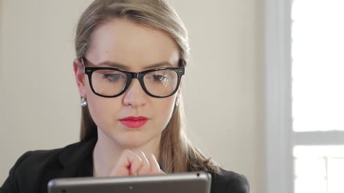 Professional Woman Using Tablet Device in Bright Office