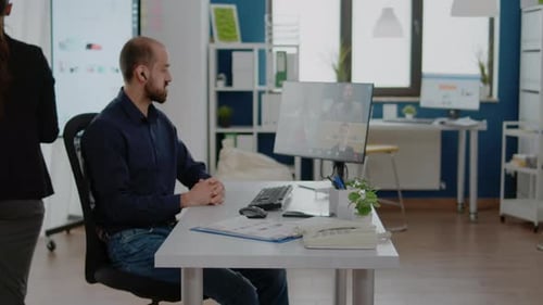 Man in Office on Video Conference with Coworkers