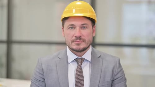 Portrait of Serious Middle Aged Engineer Looking at the Camera