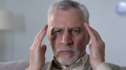 Senior Man Massaging Temples, Experiencing Headache