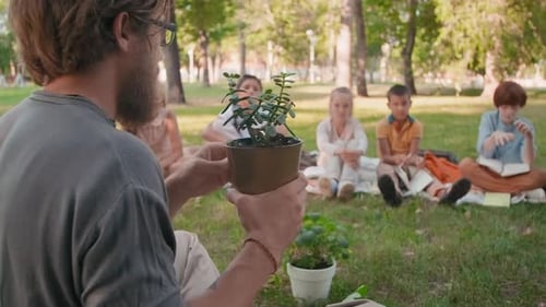 Man Teaching Biology Class in Park