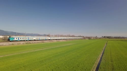 Train Traveling Through Rural Landscape on Sunny Day