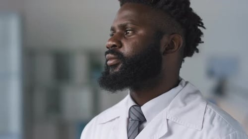 Medical Professional with Stethoscope Poses in Lab Coat