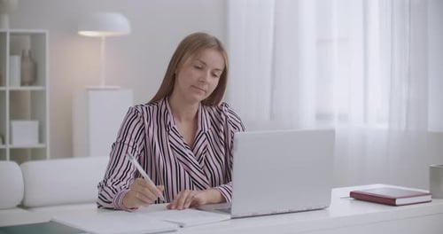 Depressed and Tired Young Woman Working in Home Office, Grabbing Her Head and Throwing Pen
