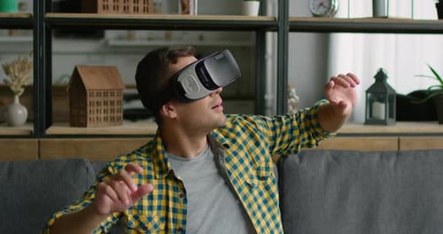Man Wearing Virtual Reality Headset Indoors on Couch