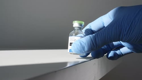 COVID-19 Vaccine Vial Placed on Surface