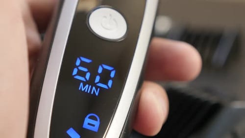 Testing battery autonomy on cordless barber set 4K 2160p 30fps UHD footage - Close-up of modern mul