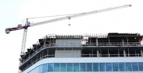 Crane Lifting Building Materials at Construction Site