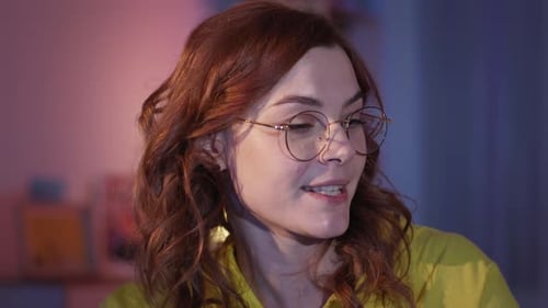 Woman Singing and Playing Acoustic Guitar at Home
