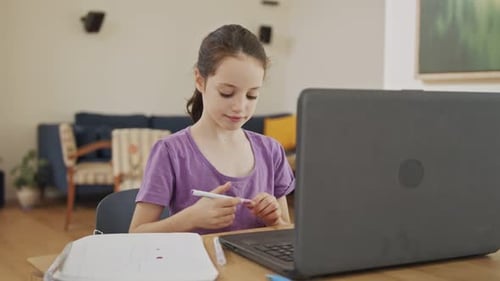 Girl Draws and Uses Laptop at Home