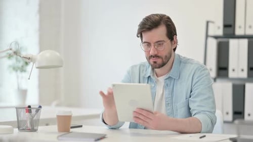 Adult Using Tablet at Clean White Office Desk