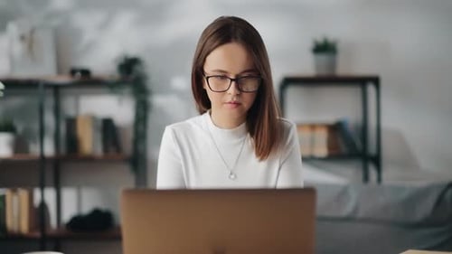 Woman Working on Laptop at Home Office Desk