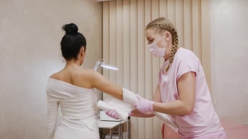 Medical Professional Wrapping Arm in Bandage