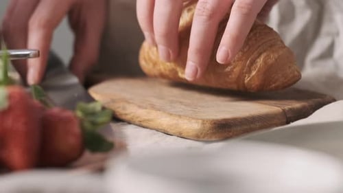 Cutting a Golden Croissant with a Knife