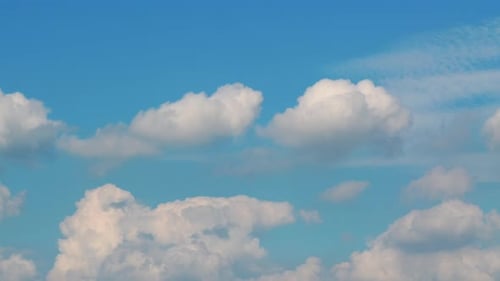 Clouds Drifting Across Light Blue Sky