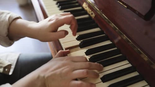 Woman Plays Piano Keyboard in Home