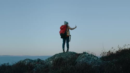 Female Hiker Taking Pictures on Mountain Peak