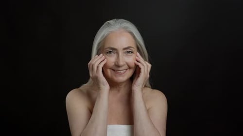 Smiling Senior Woman Modeling Skincare Routine