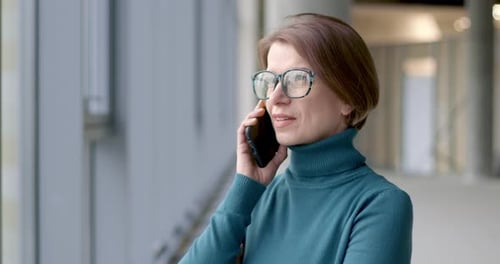 Woman Talking on Phone in Modern Office Building
