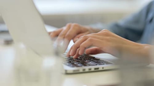 Close Up of African Woman Typing on Laptop