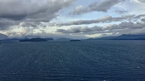 Slowmo Shot of Ocean Horizons, Island, Mountain Silhouettes and Skies