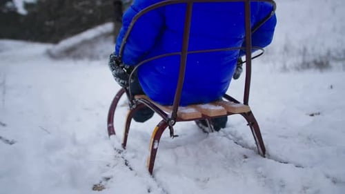 Winter Activities a Small Cute Male Child Gets Into the Sled While Having Fun with His Family in the